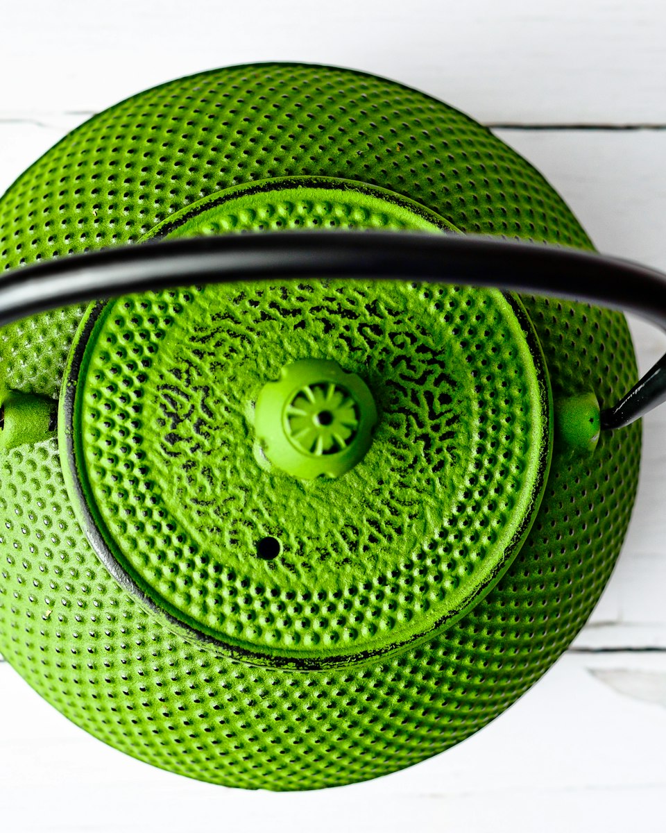 A green cast-iron tetsubin kettle seen from above